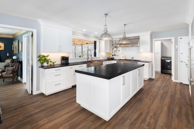 kitchen featuring white cabinetry, hanging light fixtures, and decorative backsplash