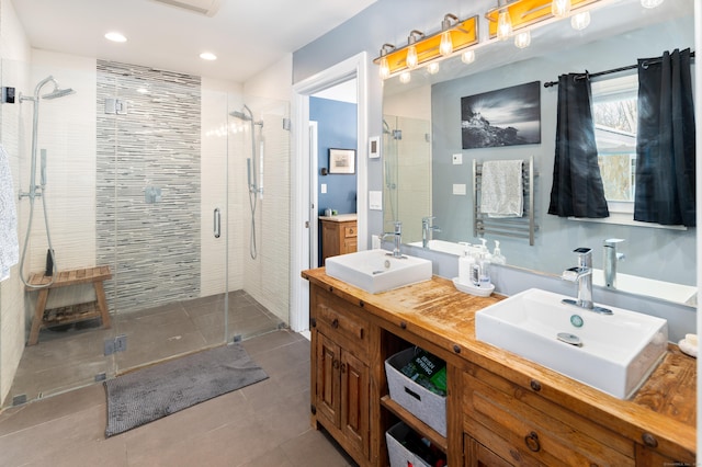 bathroom featuring vanity and a shower with door