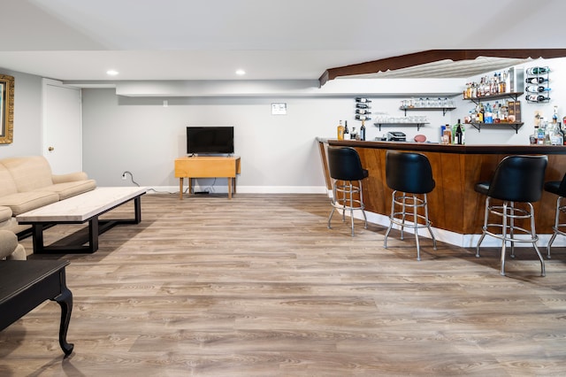 bar with light hardwood / wood-style floors