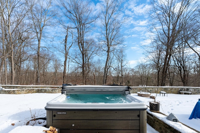 snowy yard featuring a hot tub