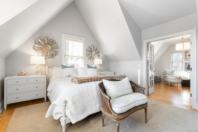 bedroom featuring vaulted ceiling and light wood-type flooring