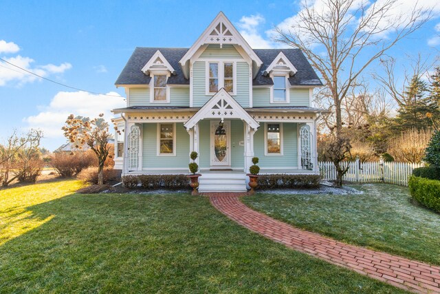 victorian home featuring a front yard and covered porch