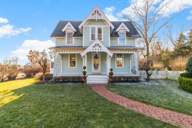 victorian home featuring a front yard and covered porch