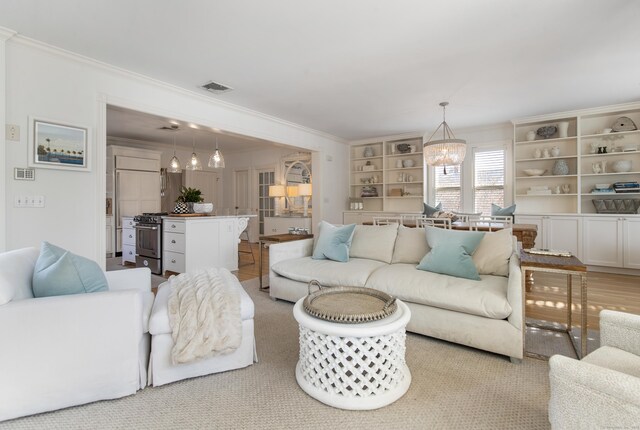 living room featuring ornamental molding and a chandelier