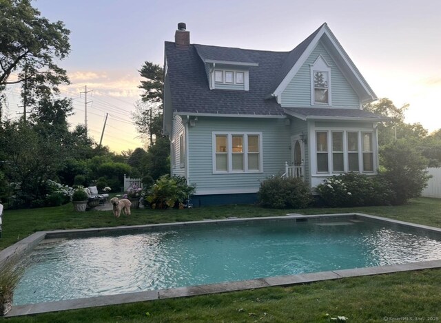 back house at dusk with a yard