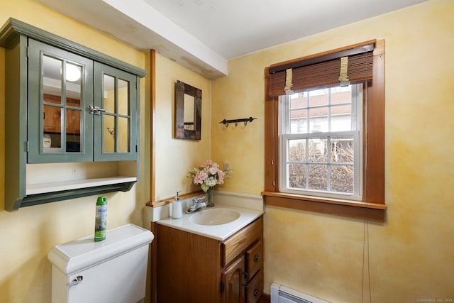 bathroom with a baseboard radiator, toilet, and vanity