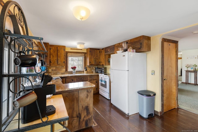 kitchen featuring white appliances, kitchen peninsula, dark wood-type flooring, and tasteful backsplash