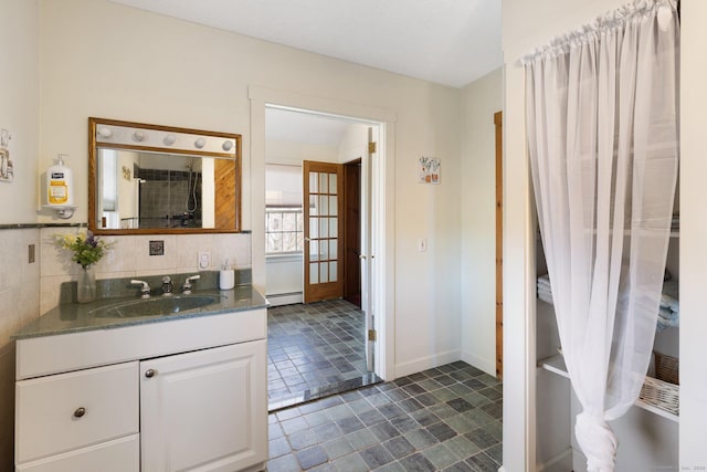 bathroom with vanity and a baseboard heating unit