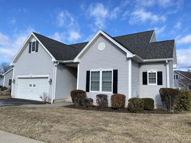 view of front of home featuring a garage and a front lawn