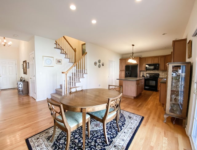 dining area featuring a notable chandelier and light hardwood / wood-style flooring