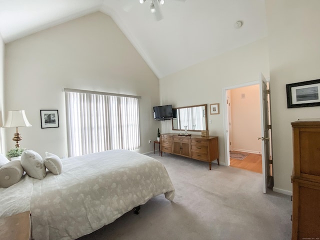 bedroom with high vaulted ceiling, light colored carpet, and ceiling fan