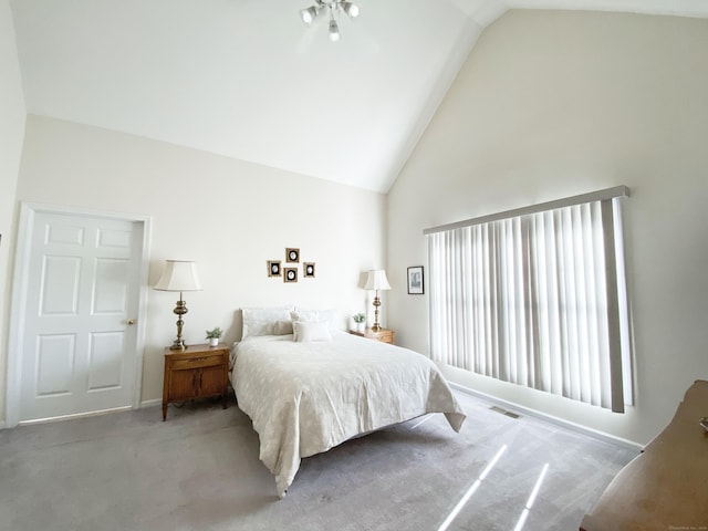 carpeted bedroom featuring high vaulted ceiling