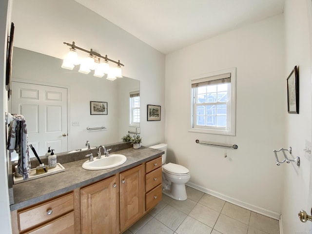 bathroom with vanity, tile patterned floors, and toilet