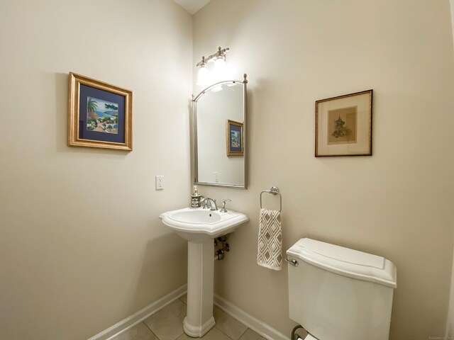 bathroom with tile patterned flooring and toilet