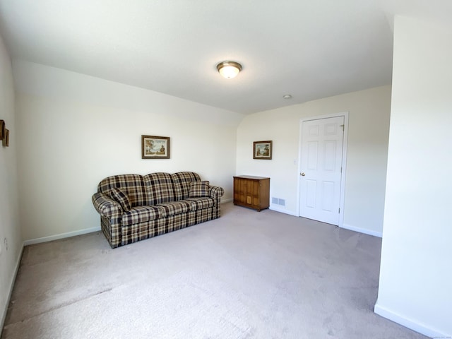 living area with carpet flooring and vaulted ceiling