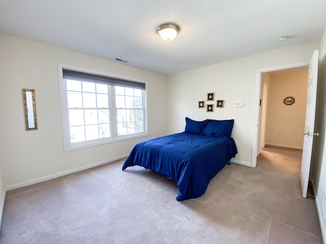 bedroom featuring light colored carpet