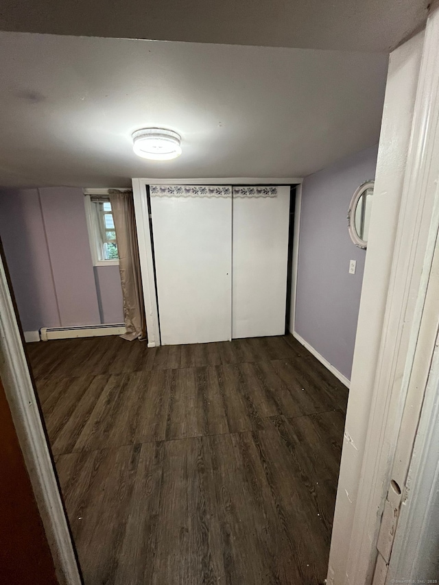 57 Prospect St, Greenwich, CT 06830 - unfurnished bedroom with a closet, dark hardwood / wood-style floors, and a baseboard radiator