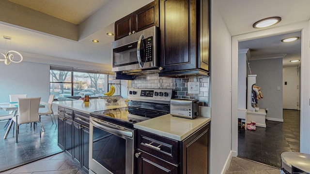 kitchen featuring a notable chandelier, decorative backsplash, dark brown cabinets, and stainless steel appliances