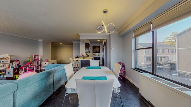 dining area with crown molding and a textured ceiling