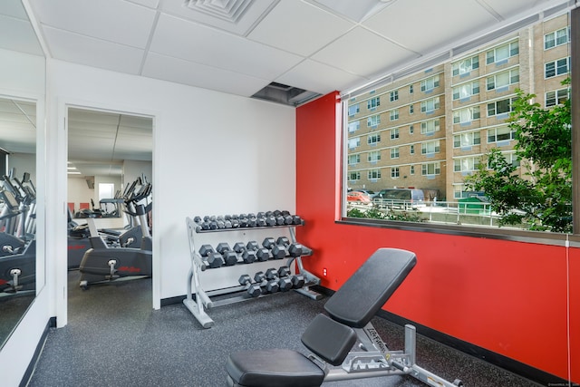 gym with a paneled ceiling