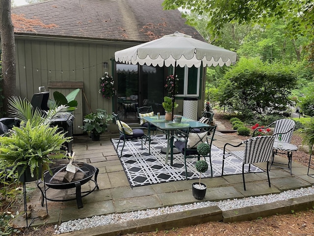 view of patio / terrace featuring an outdoor fire pit