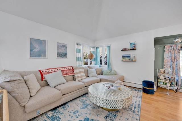 living room with baseboard heating and wood-type flooring