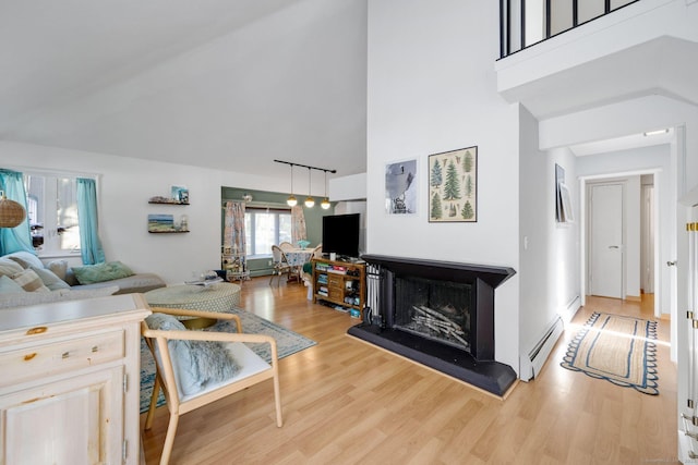 living room featuring light wood-type flooring and baseboard heating