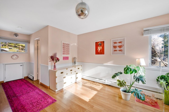 bedroom featuring light hardwood / wood-style floors and baseboard heating