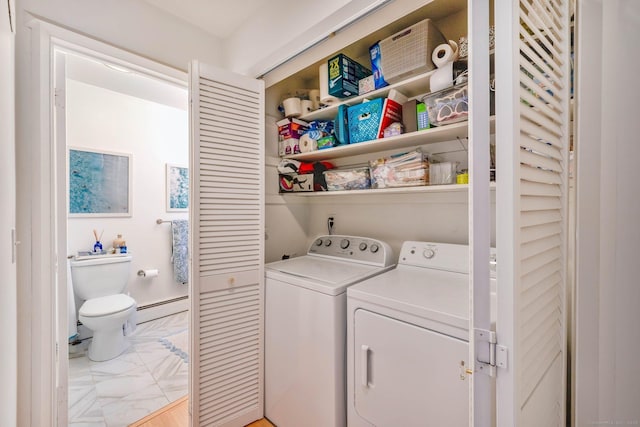 laundry area with a baseboard radiator and washing machine and dryer