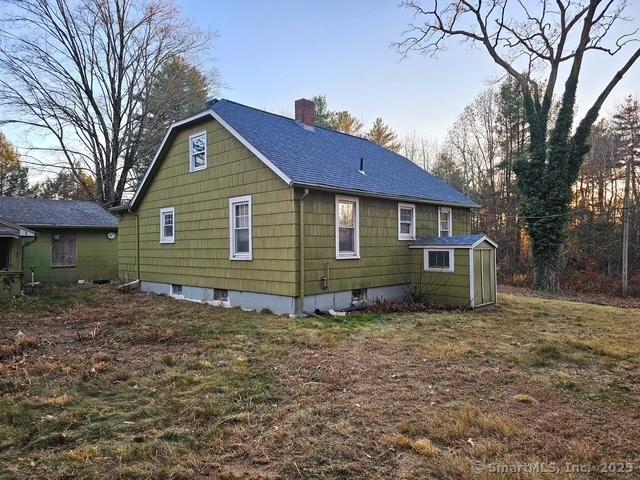 view of home's exterior featuring a chimney and a shingled roof