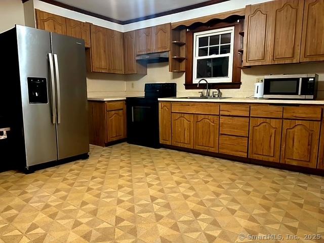 kitchen featuring a sink, light countertops, brown cabinets, and stainless steel appliances