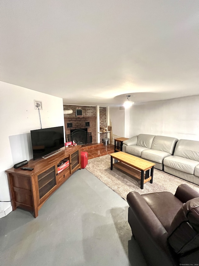 living room featuring a fireplace and concrete flooring