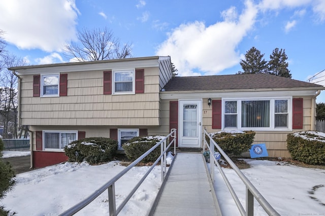 tri-level home with a shingled roof