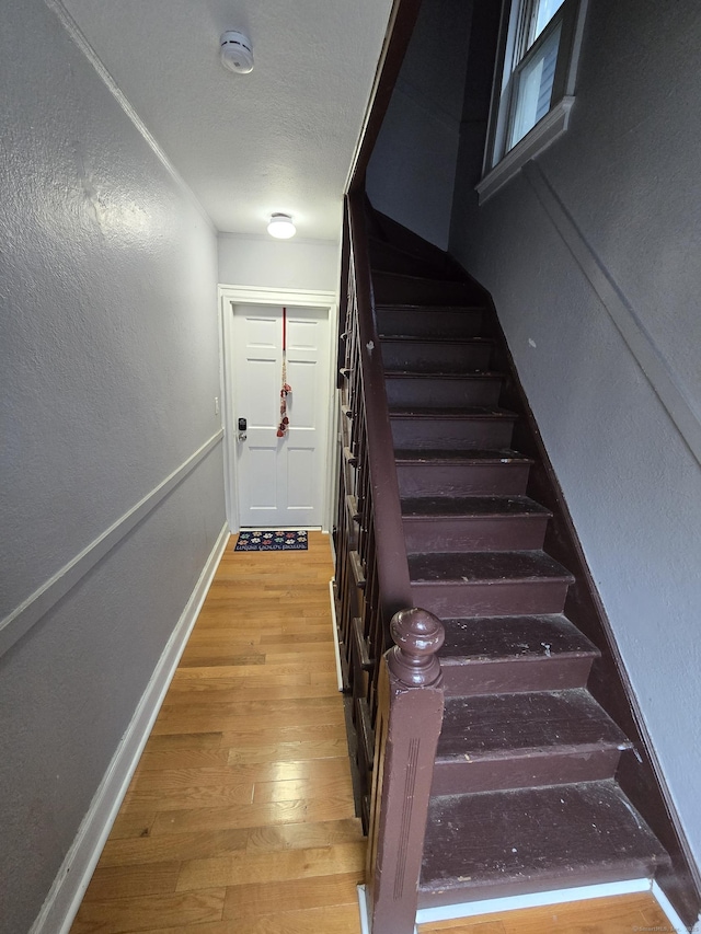 staircase featuring wood-type flooring