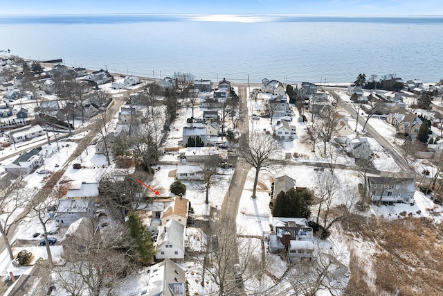 snowy aerial view featuring a water view