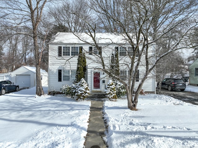 view of front of property featuring a garage and an outdoor structure