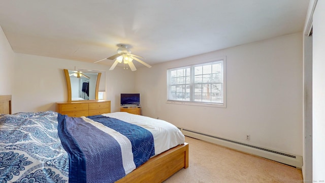 carpeted bedroom featuring ceiling fan and a baseboard radiator