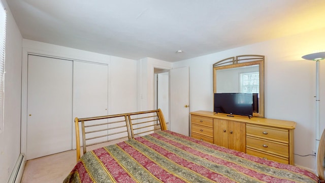 carpeted bedroom with a baseboard radiator and a closet