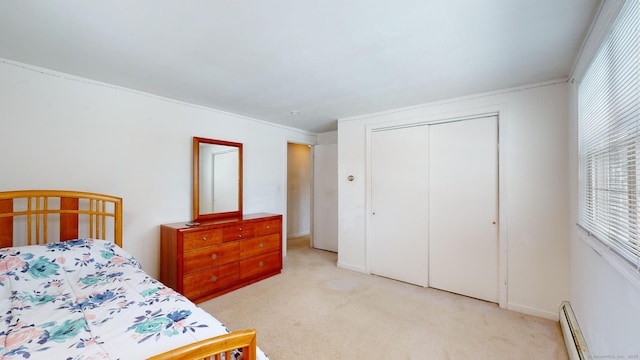 carpeted bedroom with a baseboard radiator and a closet