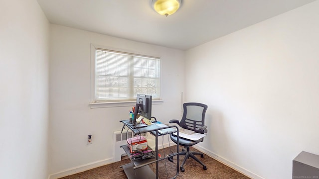 office area featuring dark colored carpet and radiator