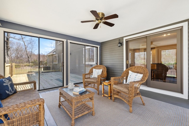 sunroom featuring ceiling fan