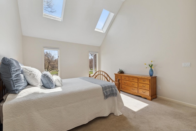 carpeted bedroom featuring a skylight, baseboards, and high vaulted ceiling