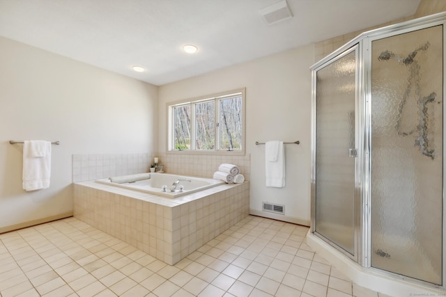 bathroom featuring tile patterned flooring, visible vents, baseboards, a garden tub, and a stall shower