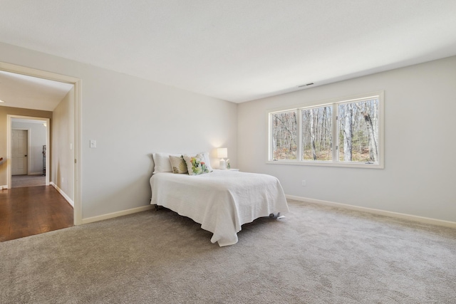 carpeted bedroom featuring baseboards and visible vents