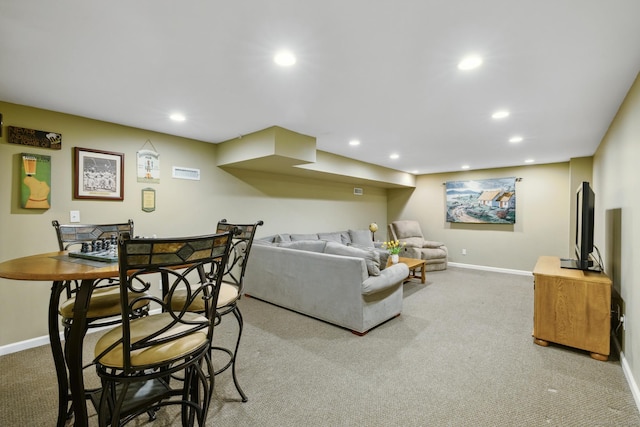 carpeted living area with recessed lighting and baseboards