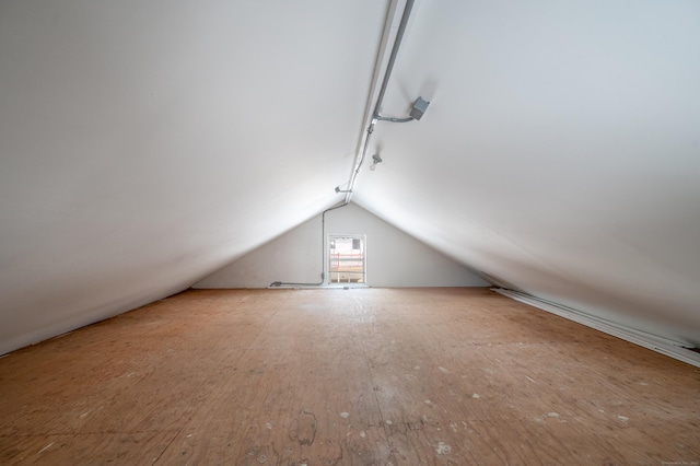 additional living space featuring hardwood / wood-style floors and vaulted ceiling