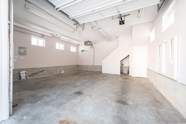 garage featuring a garage door opener and electric panel