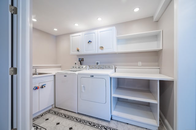 laundry area with sink, cabinets, and washer and clothes dryer