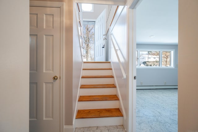 stairs with a healthy amount of sunlight and a baseboard heating unit