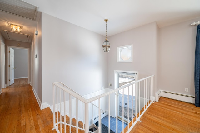 hall featuring a baseboard radiator and wood-type flooring